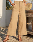 High-rise Ryder Pants with wide-leg ankle-length fit, side pockets, and tortoise buttons in stretch cotton twill