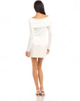 Woman wearing white Jillian off-the-shoulder top with twist front and long sleeves.