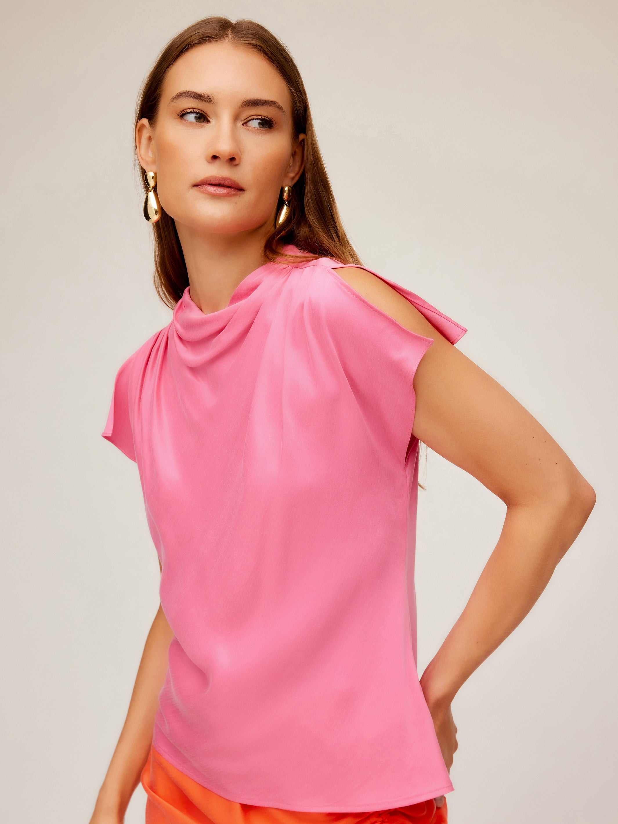 Woman wearing pink Emmeline blouse with silky cupro material and split cap sleeves