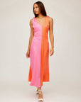 Woman wearing Verity Two-Tone Midi Dress in coral and pink with A-line silhouette and pleated detail