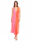 Woman wearing Verity Two-Tone Midi Dress in coral and pink with pleated A-line silhouette and low V-neck