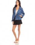 woman wearing Chelsea Cropped Trench denim jacket with boxy fit, notch collar, and double breast button closure