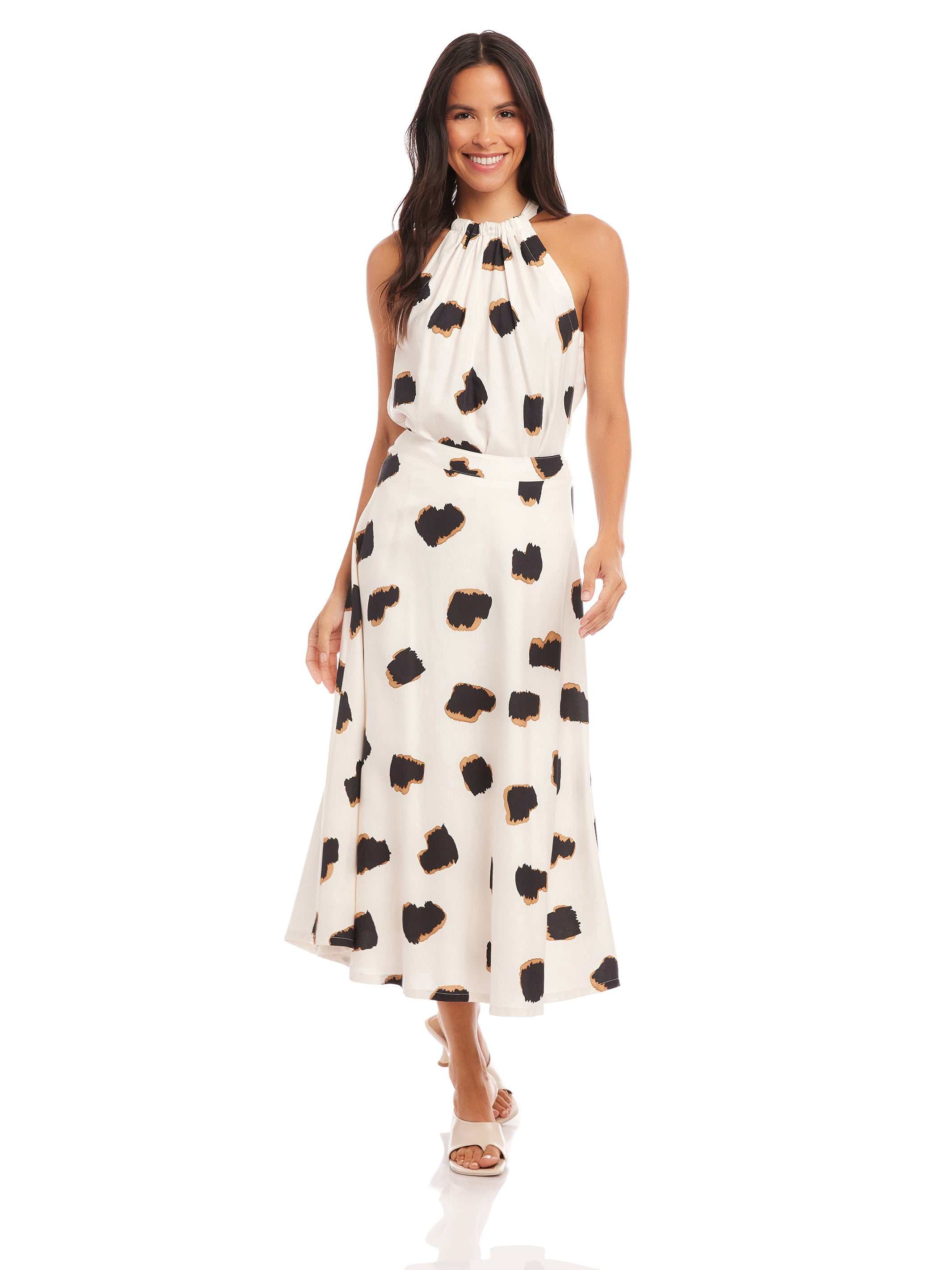 Woman wearing a high-waisted flowy midi Lexi Skirt with Sahara twill print paired with a matching sleeveless top.