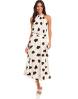 Woman wearing a high-waisted flowy midi Lexi Skirt with Sahara twill print paired with a matching sleeveless top.