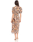 Woman wearing Poppy Shirred Waist Dress with paisley print and short puff sleeves, back view