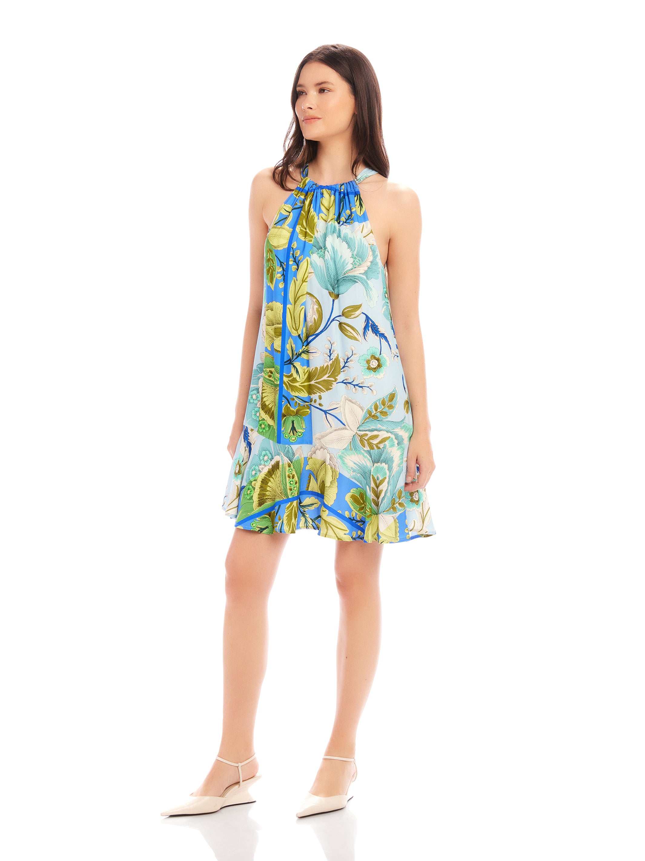 Woman wearing sleeveless Brenda Ruffle Hem Dress with botanical floral scarf print and halter neckline