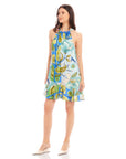 Woman wearing sleeveless Brenda Ruffle Hem Dress with botanical floral scarf print and halter neckline