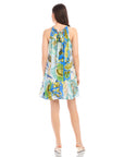 Back view of a woman wearing a sleeveless Brenda Ruffle Hem Dress with botanical floral scarf print and ruffle hem.