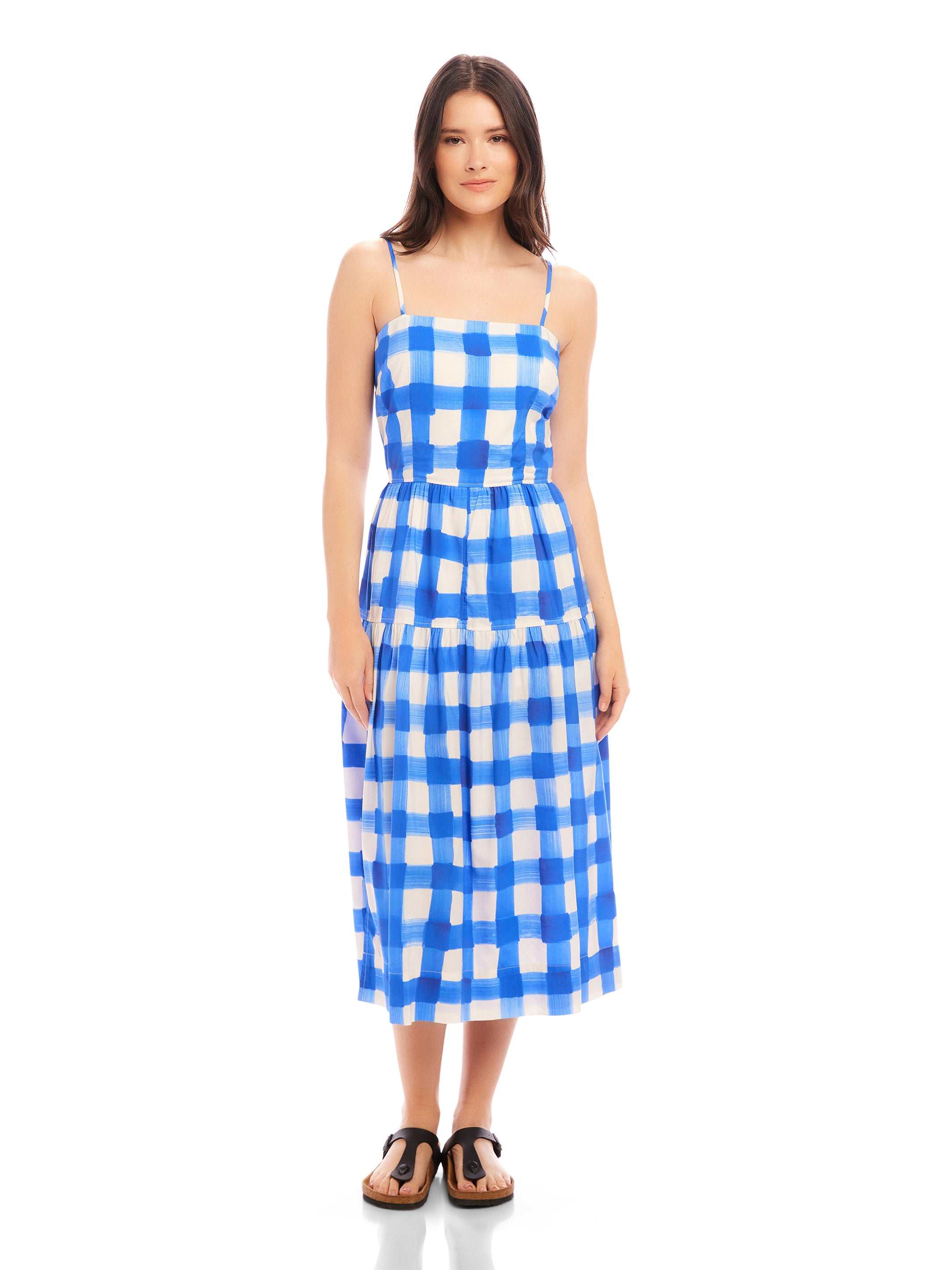 Woman wearing blue and white watercolor check Costa Dress with adjustable spaghetti straps and square neck