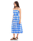 Woman wearing blue and white watercolor check Costa Dress with adjustable spaghetti straps and square neck, featuring A-line silhouette.
