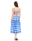 Woman wearing Costa Dress in blue and white watercolor check print with open back and adjustable spaghetti straps
