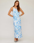 Woman wearing Sera A-Line Dress in blue painted paisley print with adjustable spaghetti straps and maxi length