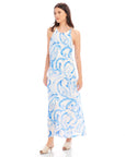 Woman wearing Sera A-Line Dress with blue painted paisley print and adjustable spaghetti straps in maxi length