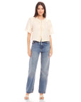 Nadine Bow Detail top in cream linen with front tie closure and short puff sleeves paired with high waist blue jeans