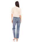 Woman wearing Nadine Bow Detail linen top with short puff sleeves and high waist jeans viewed from the back