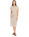 Woman wearing a Lucia Stripe Dress with vertical stripes, boxy fit, cap sleeves, collared neck, and side slit.