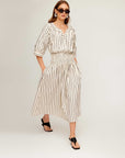 Woman wearing Rhea Stripe Skirt midi length with elasticized high waist in striped cotton fabric