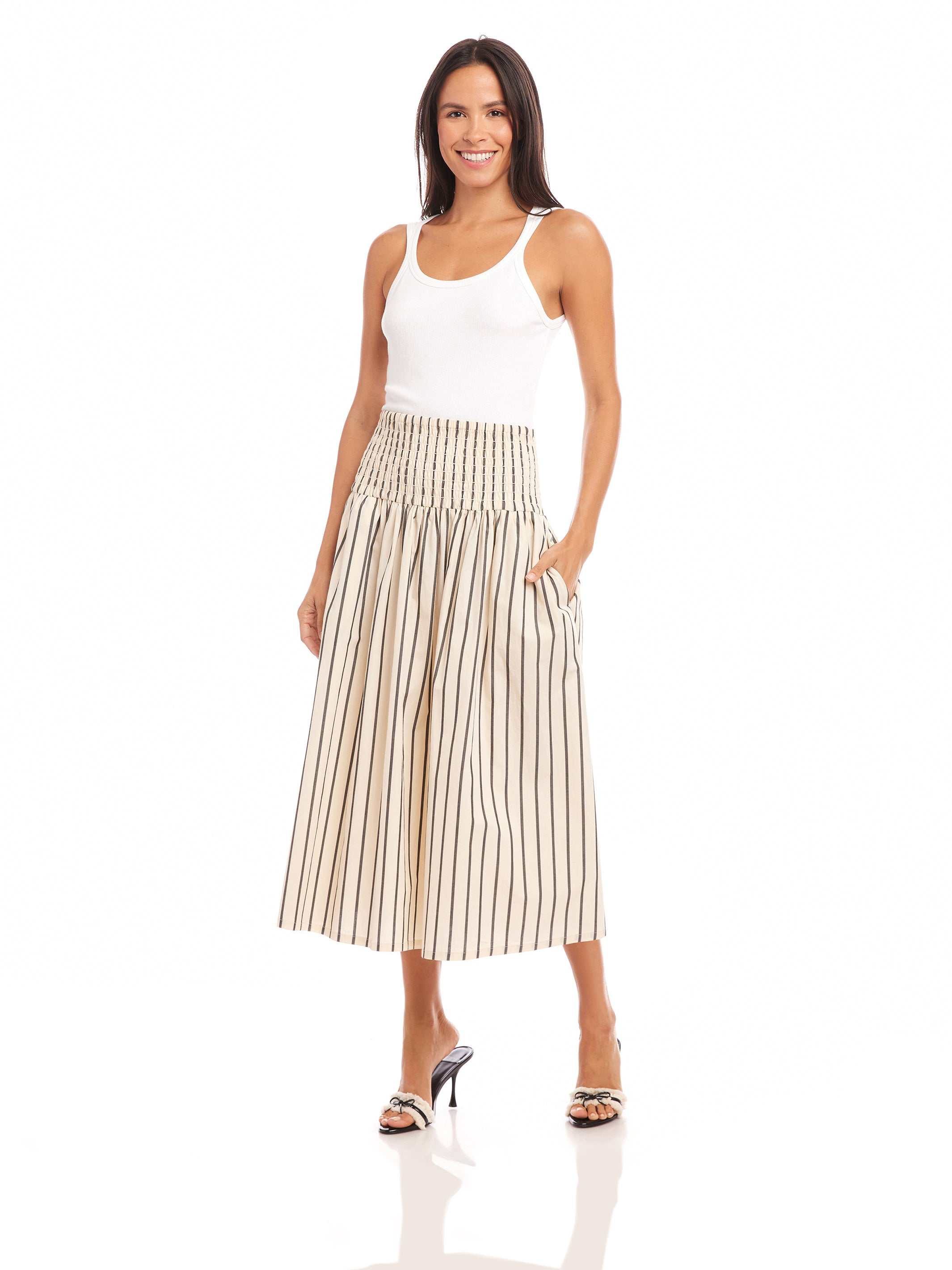 Woman wearing midi length Rhea Stripe Skirt with elasticized sheered waist and vertical stripes