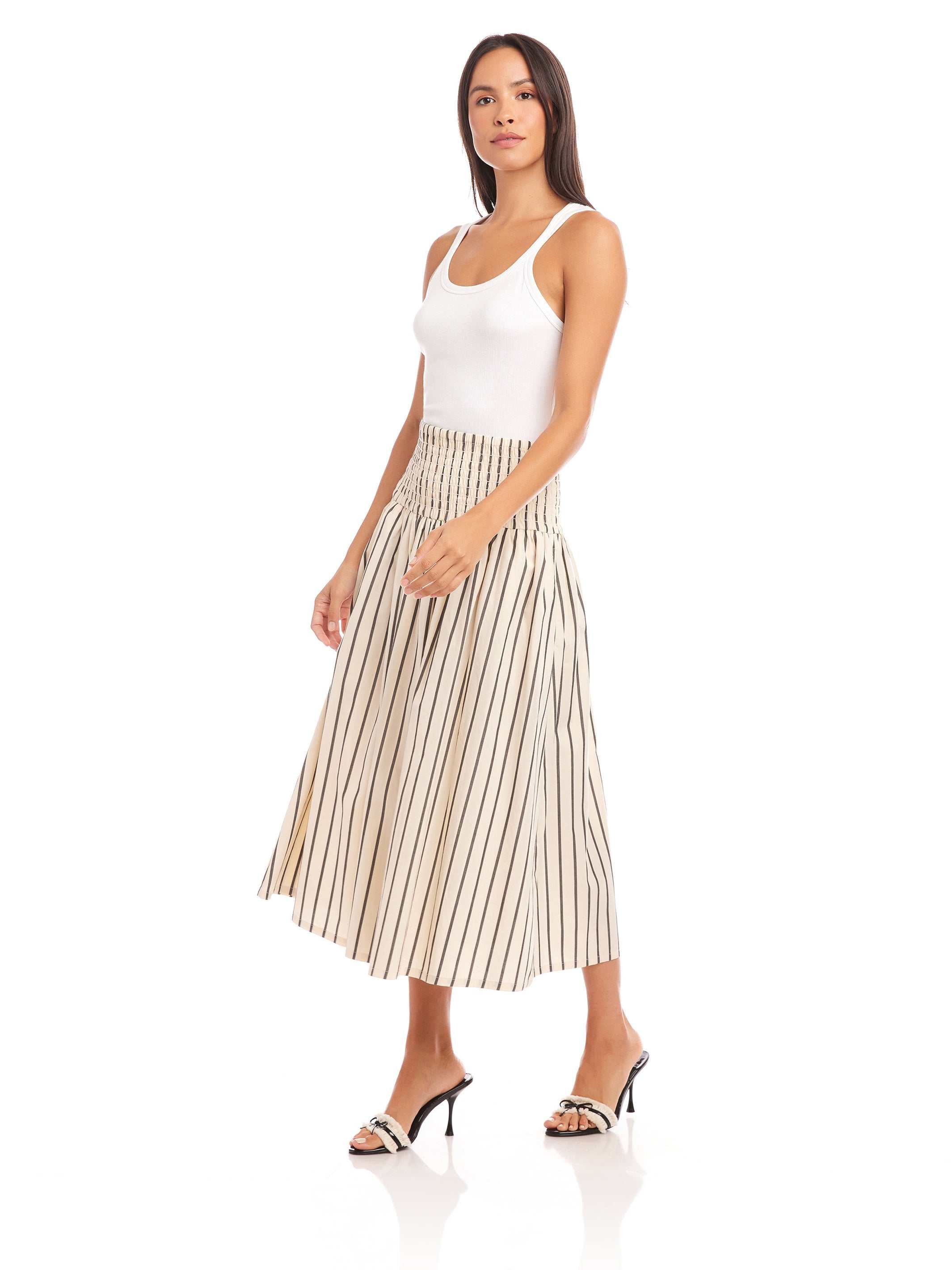 Woman wearing Rhea Stripe Skirt midi length striped cotton skirt with elasticized sheered waist and high waist fit.