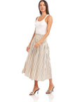 Woman wearing Rhea Stripe Skirt midi length striped cotton skirt with elasticized sheered waist and high waist fit.