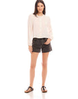 Aubrey Button-Up Blouse with textured pucker woven fabric, long bishop sleeves, round neck, and front button closure styled with black shorts.
