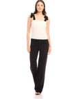 Woman wearing Annie Ribbon Tie Top white sleeveless square neck blouse with black ribbon straps and black pants