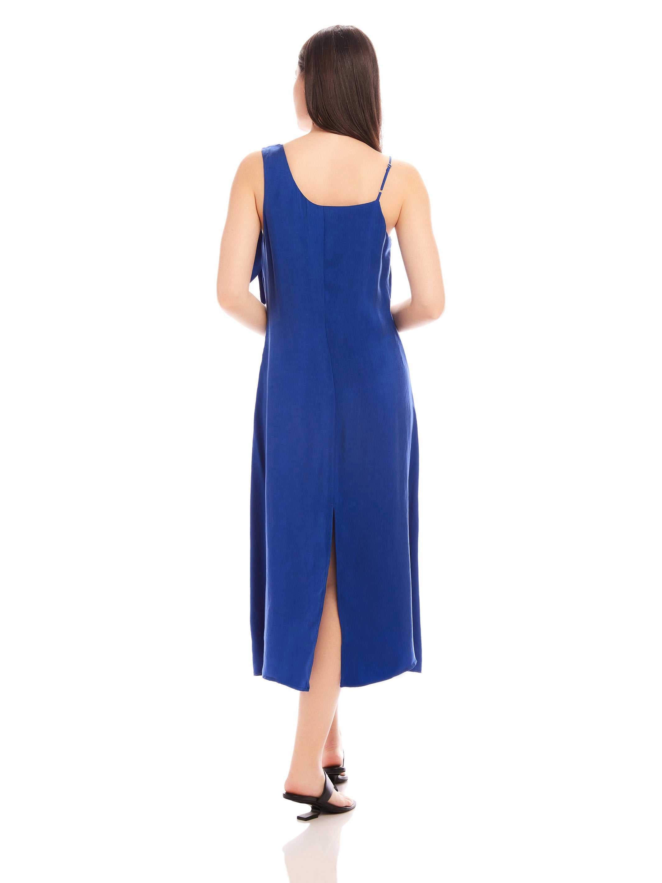 Back view of woman wearing blue Serena Midi Dress with back slit and adjustable shoulder straps