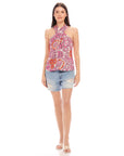 Woman wearing Sasha Halter Top with retro floral print paired with denim shorts