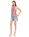 Woman wearing Sasha Halter Top with retro floral print and blue denim shorts