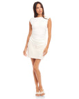 Woman wearing white Tasha Side-Shirred Top with cap sleeves and boatneck paired with light skirt.