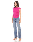 Woman wearing fuchsia Tasha Side-Shirred Top with boatneck, cap sleeves, and side shirring paired with blue jeans and heels