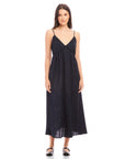 Woman wearing a black Leanna Midi Dress with adjustable spaghetti straps and V-neckline made of crushed satin
