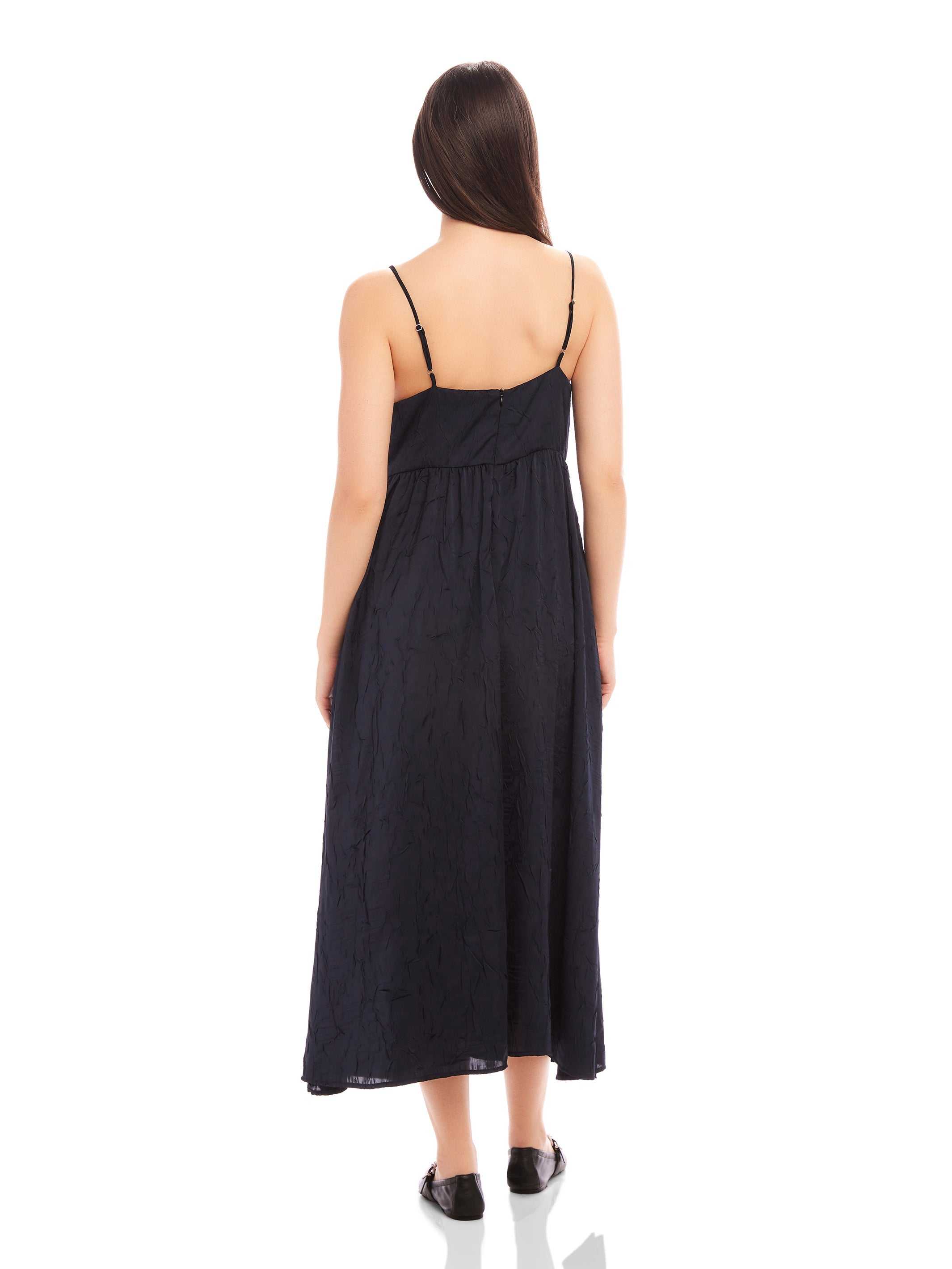 Back view of Leanna Midi Dress in black crushed satin with adjustable spaghetti straps and relaxed fit
