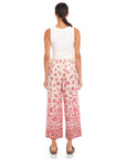 Woman wearing Etta Border Print Pants with wide leg and watercolor floral border pattern.