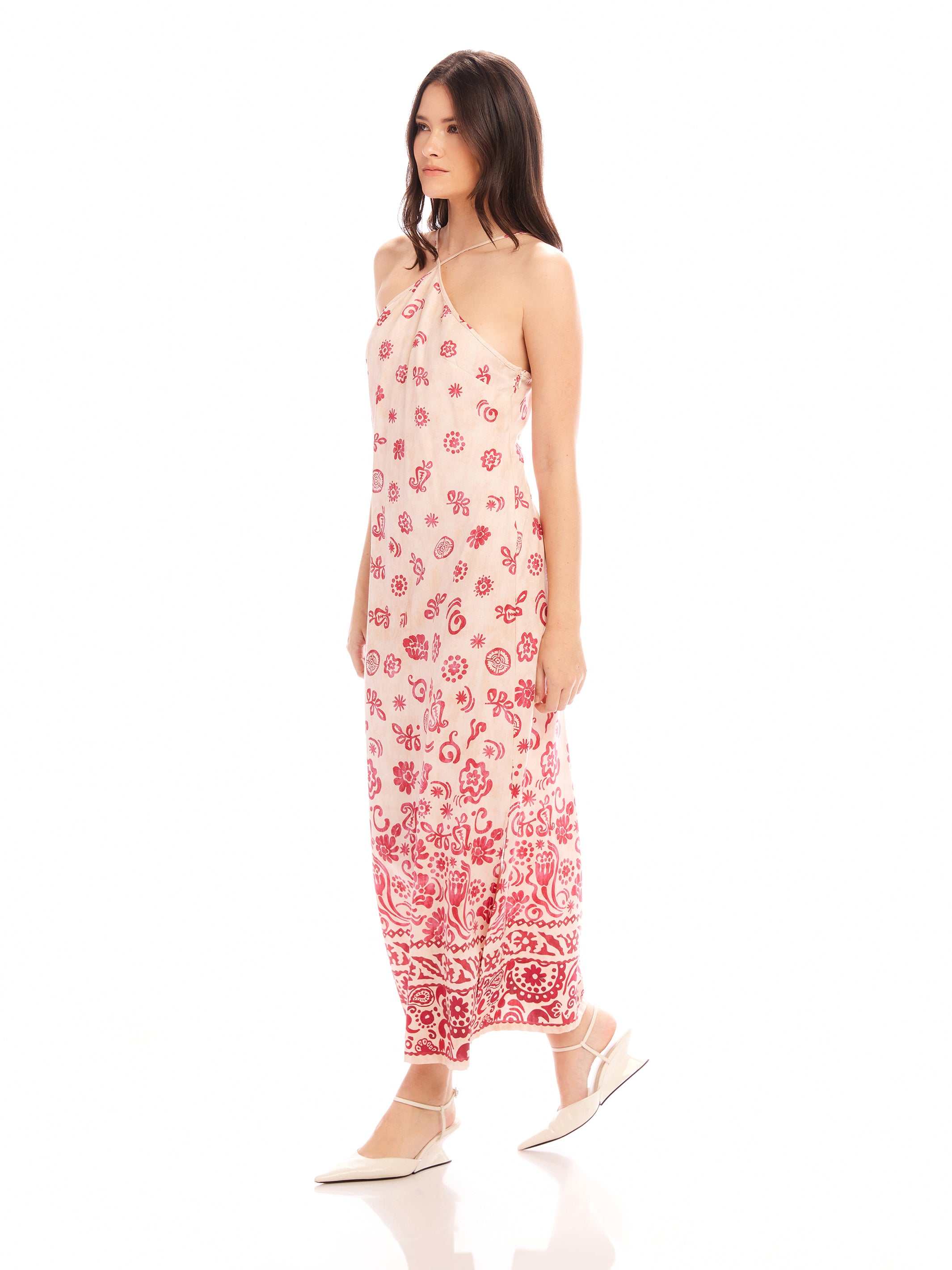 Jaylen Border Print Dress with watercolor border design, halter neckline, fitted silhouette, side slits, and adjustable straps in twill fabric