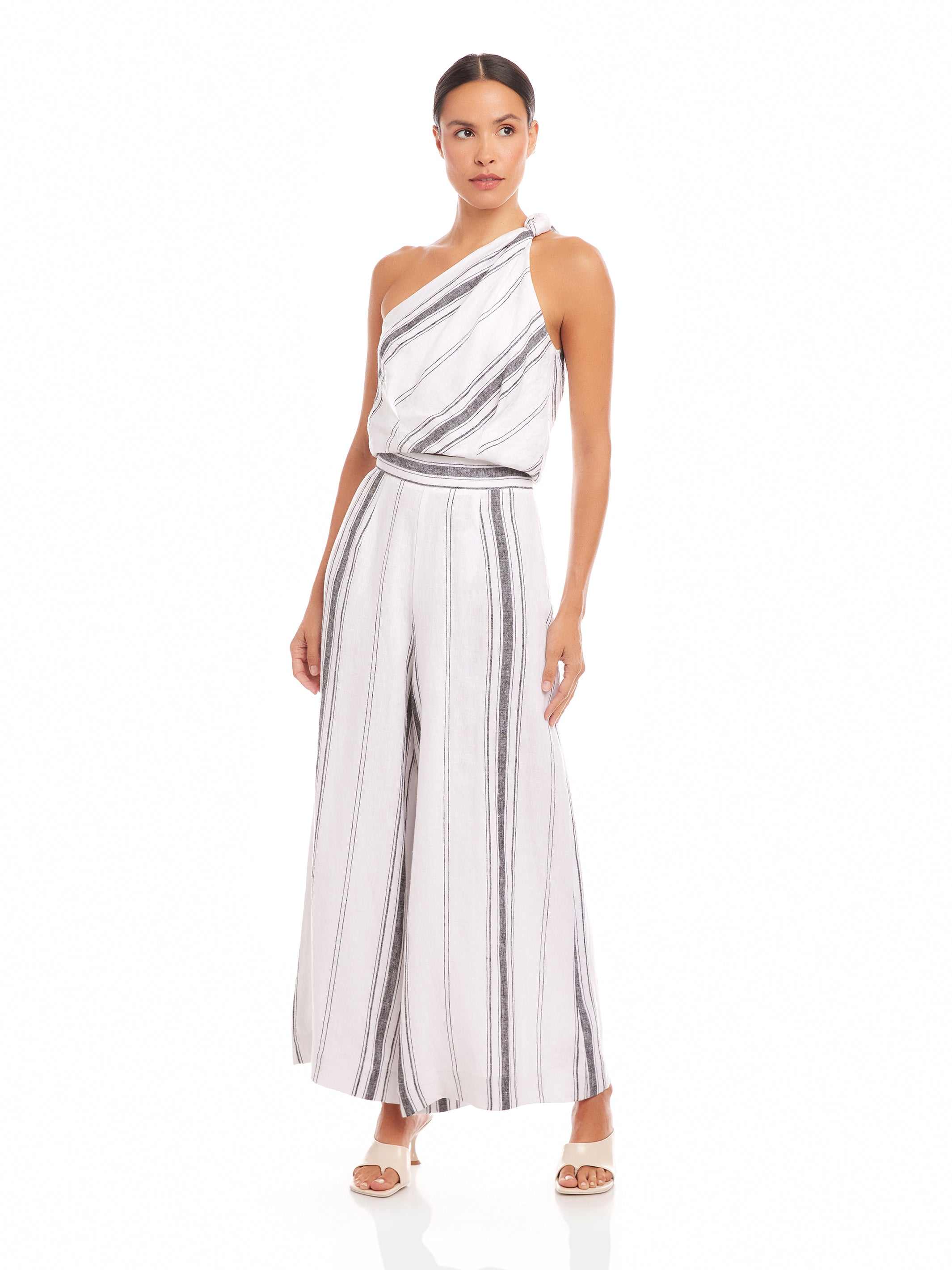 Woman wearing Vanita One-Shoulder Top in striped linen blend with matching wide-leg pants