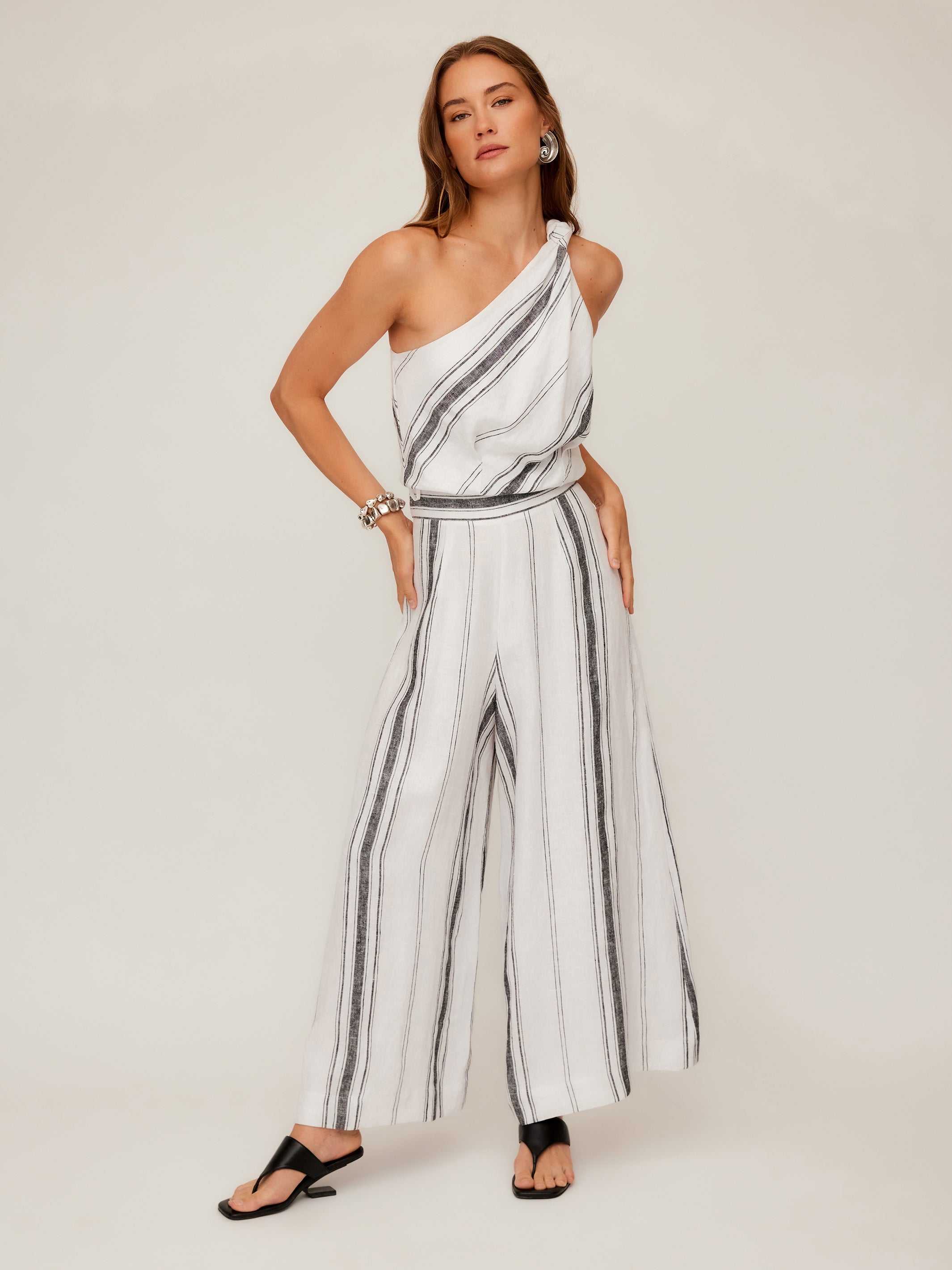 Woman wearing breathable striped Vivienne wide-leg linen blend pants with elastic waistband and full length design