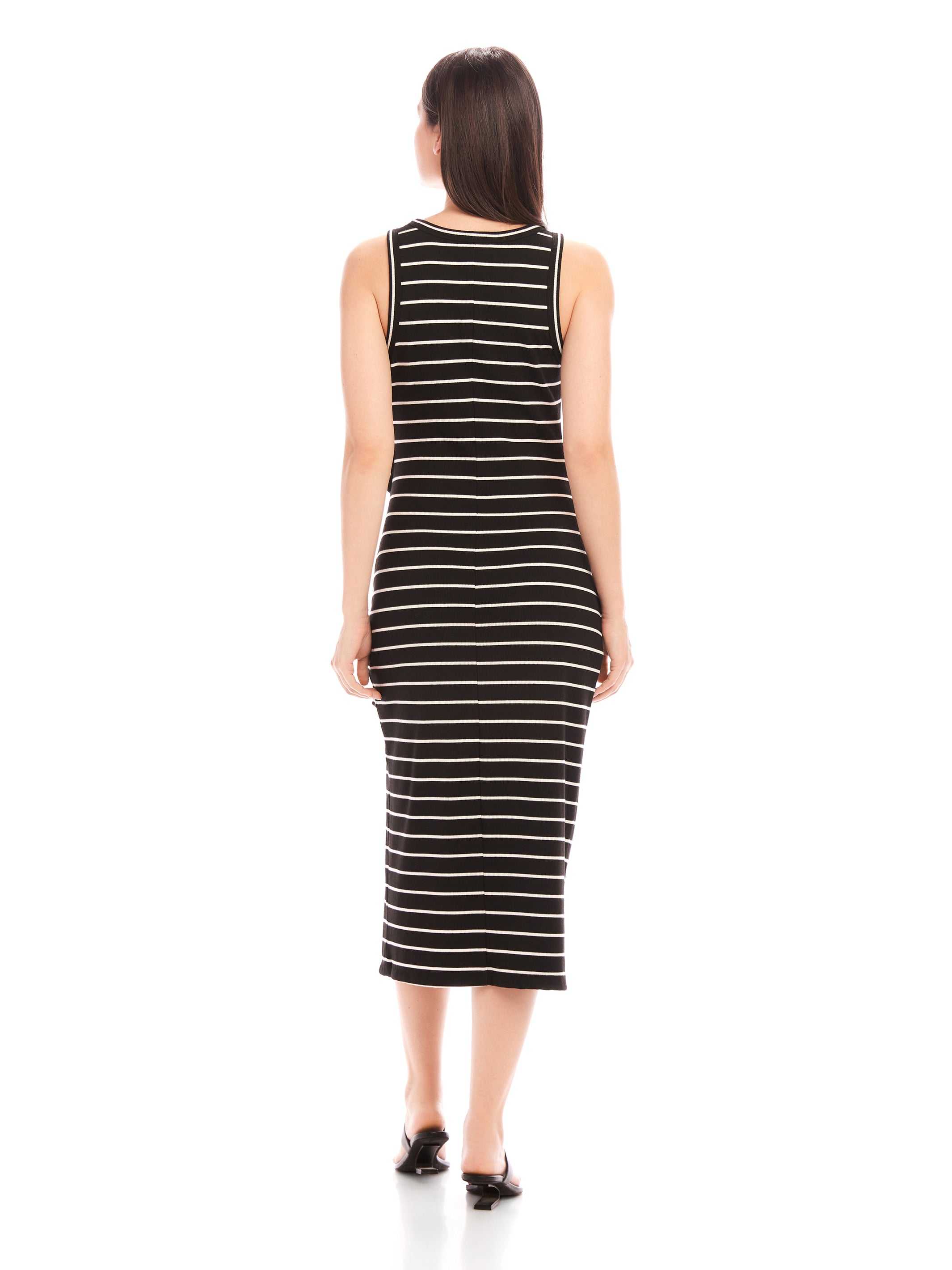 Back view of woman wearing black and white striped sleeveless Maddie Side-Knot Midi Dress with round neckline and fitted silhouette.