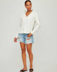 Woman wearing Vivi Contrast V-Neck Top with cream and green contrast trim and raglan long sleeves