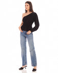 Woman wearing black Talia One-Shoulder Top with elasticized waist and peplum hem paired with blue jeans and black heels