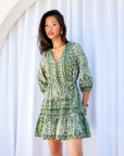 Green and off-white Tasha Tiered Dress with V-neck, button front, 3/4 sleeves, tie waist, and tiered skirt