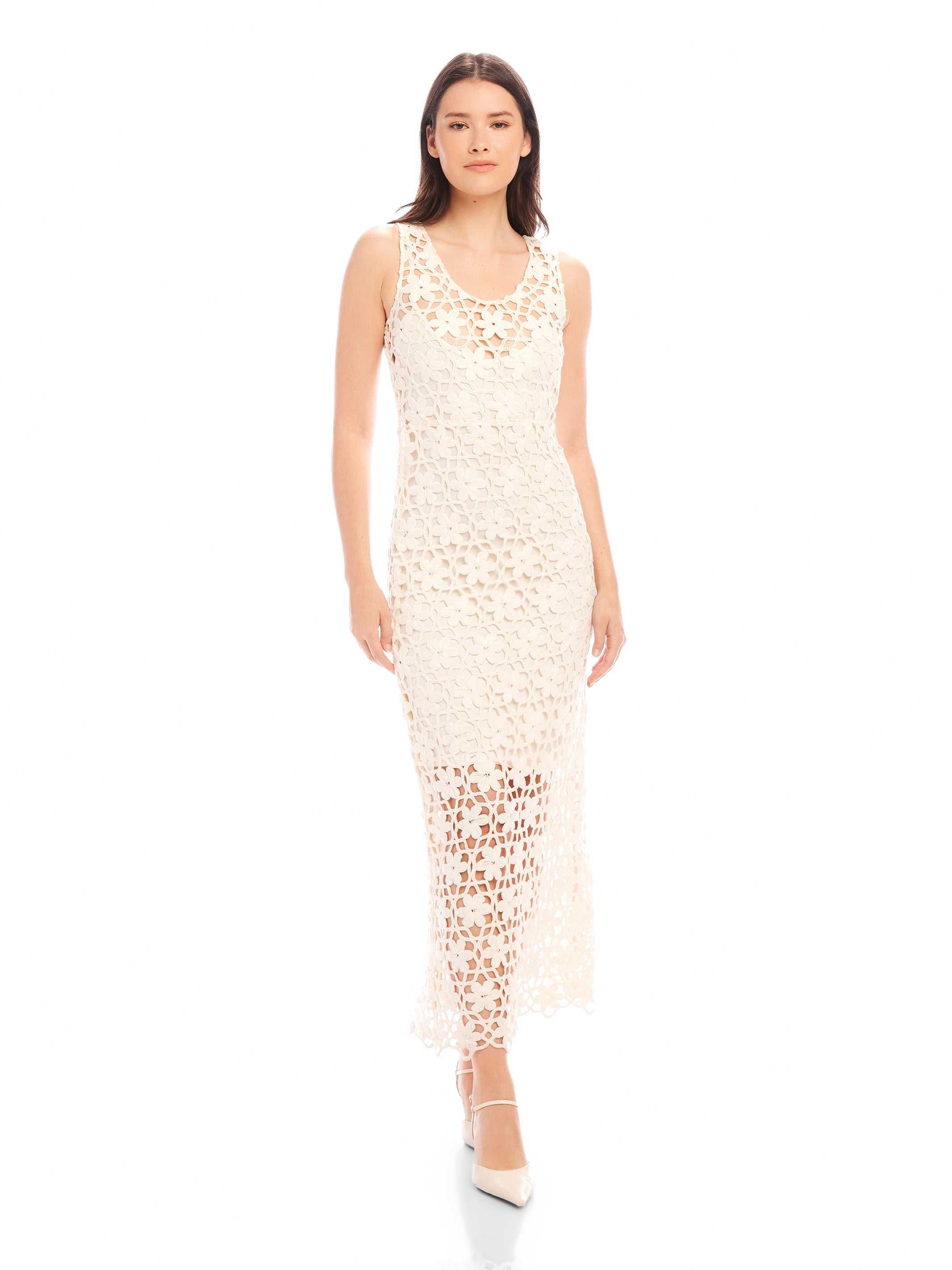 Woman wearing sleeveless Kelsie Crochet Dress with floral crochet design and scoop neckline