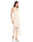 Model wearing a sleeveless Kelsie Crochet Dress with floral design and scoop neckline in white with detachable slip and side zipper closure.
