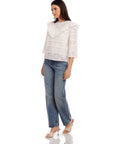 Woman wearing Flora Eyelet Lace Top with floral eyelet embroidery and ruffle trim paired with blue jeans and sandals