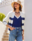 Woman wearing Cely Cropped Cardigan with white and navy stripes, paired with blue ribbed sweater vest and jeans outdoors