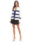 Cely Cropped Cardigan white with blue stripes worn with black shorts and blue top