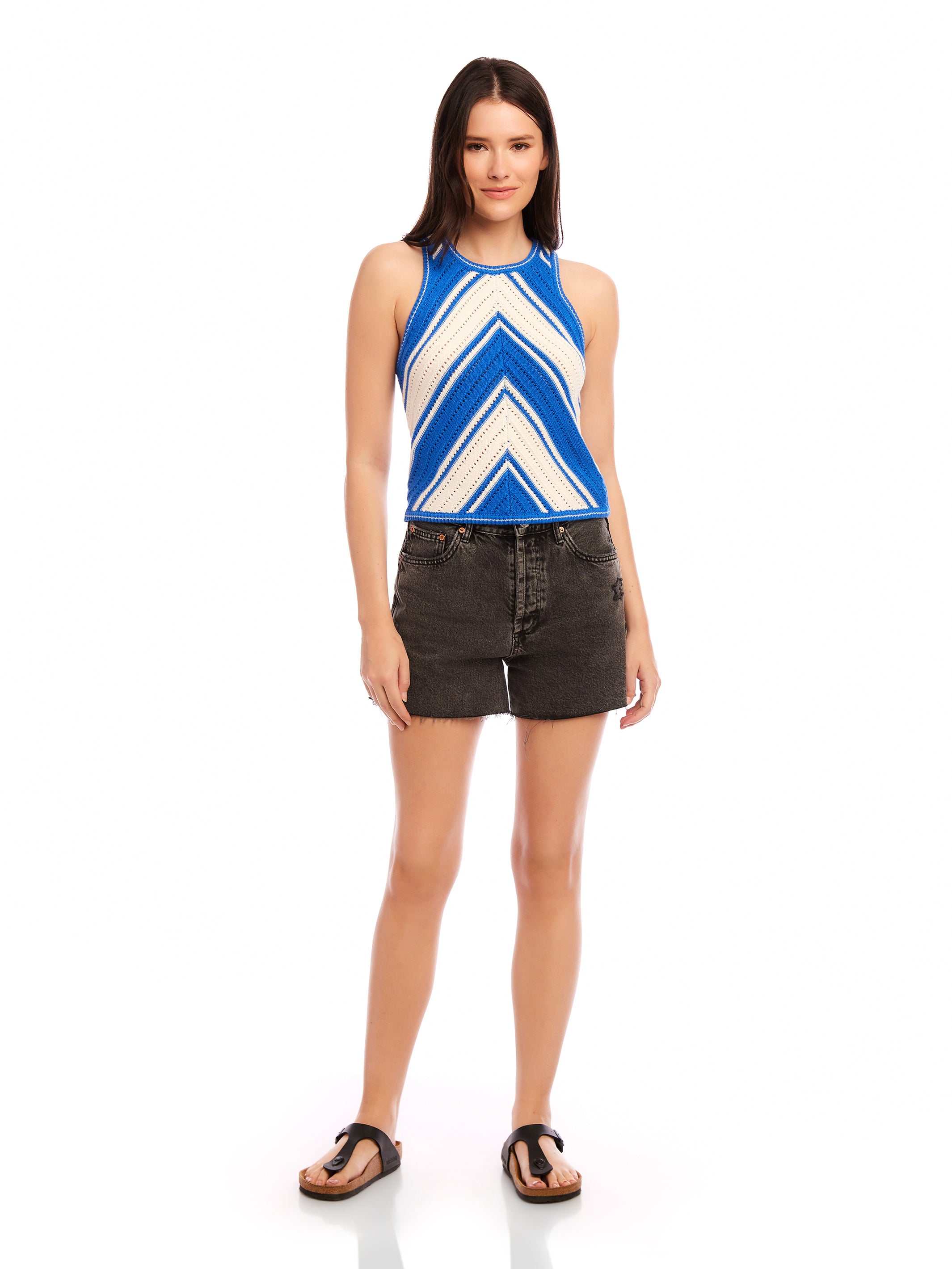 Woman wearing blue and white Alice Crochet Tank with chevron design and black high waist shorts