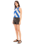 Woman wearing blue and white Alice Crochet Tank with chevron design and black high waist shorts