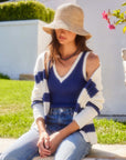 Woman wearing sleeveless Nicole Sweater Tank with V-neck and wide ribbed detail, paired with striped cardigan and jeans outdoors
