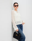 Liv Crochet Sweater with open-weave, flared sleeves, back keyhole, and delicate flower details